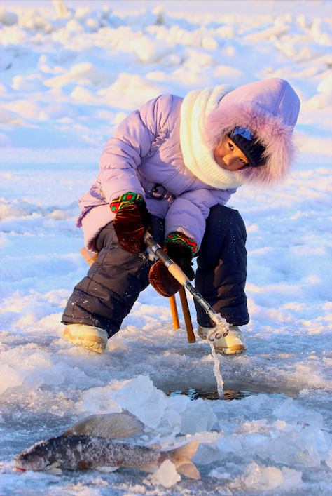 A person ice fishing.