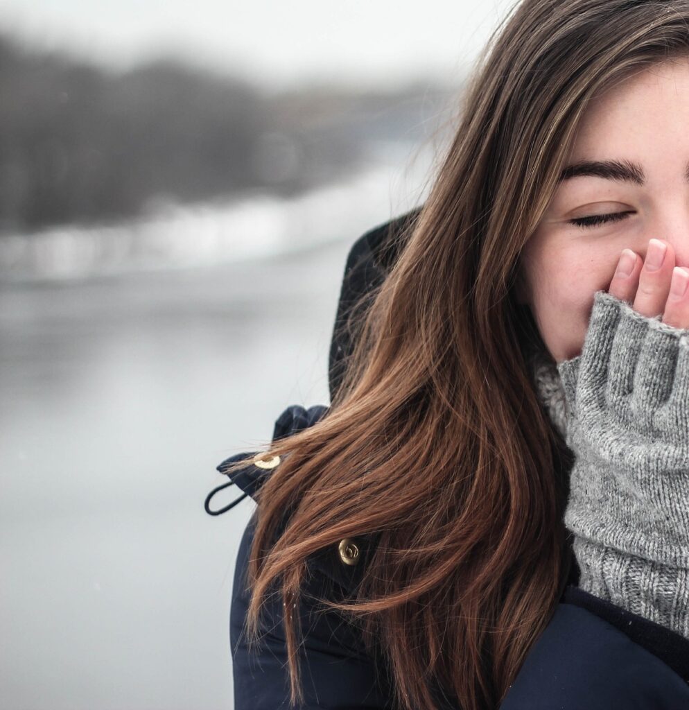 Girl holding hands over mouth to keep warm
